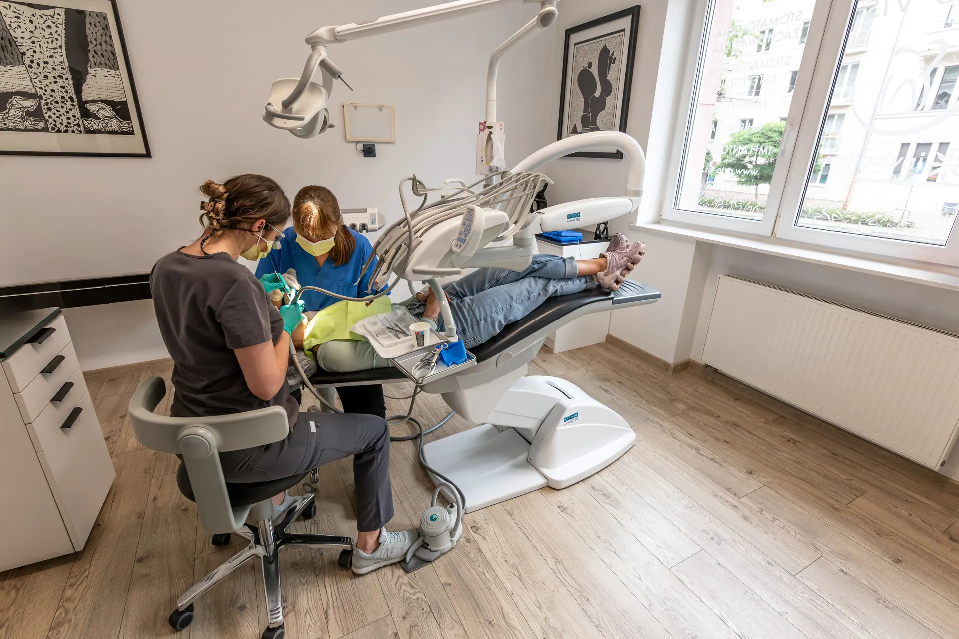 Dental treatment at Orto-vis — dentist and assistant at the chair.